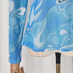 Detail view of vintage blue floral printed mesh long sleeve top hemline and cuff