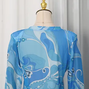 Close-up view of the back and shoulder detail on a blue vintage floral print satin top.