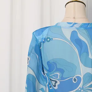 Close-up of blue vintage swirl print satin fabric showing neck detail on mannequin