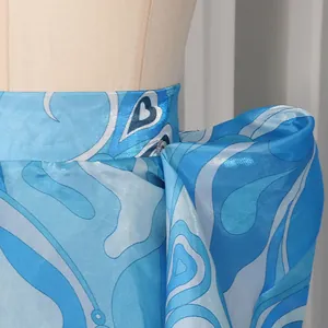 Close-up of vintage blue satin skirt with abstract heart print and waistband detail