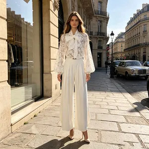 Vista completa della camicetta di pizzo bianca con fiocco e pantaloni larghi a Parigi