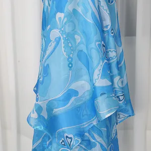 Close-up detail of a vintage satin printed skirt with an irregular hemline in blue and white