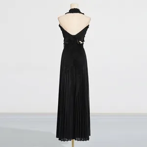 Detailed back view of black pleated halter top and wide-leg trousers set with ruffles.