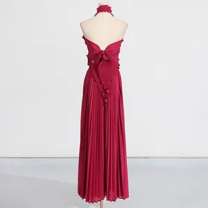 Back view of elegant pleated halter top and wide-leg trousers set with ruffle details