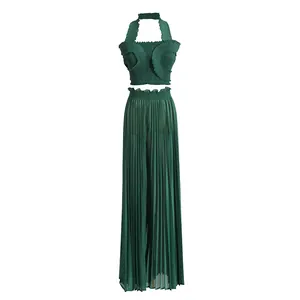 Elegant dark green pleated two-piece set with ruffled halter top and wide-leg trousers