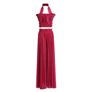 Front view of elegant pleated two-piece set with ruffle halter top and wide-leg trousers