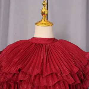 Close-up detail of luxurious red tiered pleated ruffles on a court style chiffon dress