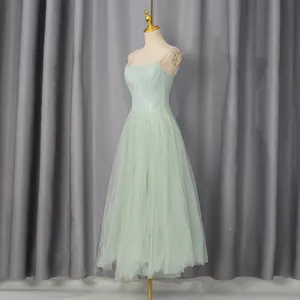 Elegant mint green court style dress with embroidered bodice and tulle mesh skirt on mannequin