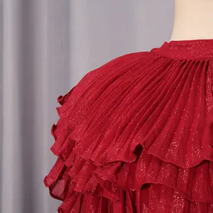 Close-up of elegant red pleated ruffles on a shimmering palace style chiffon dress