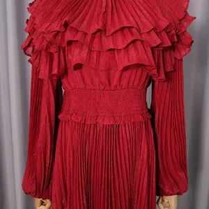 Close-up detail of a dark red pleated chiffon dress featuring ruffles and smocked waist