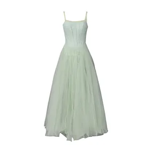 Detailed view of a light green tulle maxi dress with embroidery and thin straps