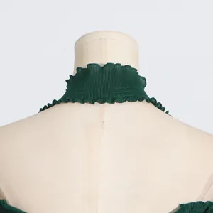 Close-up of green pleated halter neck top with ruffle detail on mannequin