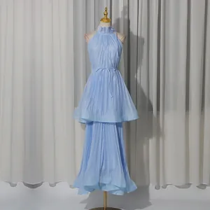 Elegant light blue halter neck pleated maxi dress with tiered ruffles on a mannequin