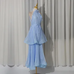 Detailed view of light blue halter sleeveless pleated tiered maxi dress on a mannequin.