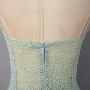 Detailed view of green lace embroidery and invisible zipper on mesh bridesmaid dress