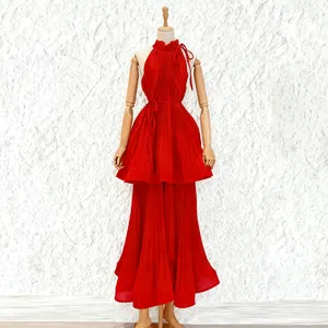 Vibrant red halter sleeveless pleated dress with ruffled neck and layered skirt design.
