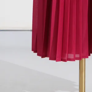 Close-up detail of magenta pleated fabric texture for high-waisted wide-leg fashion pants