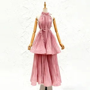 Detailed front view of a pink pleated halter neck vacation dress on a display mannequin