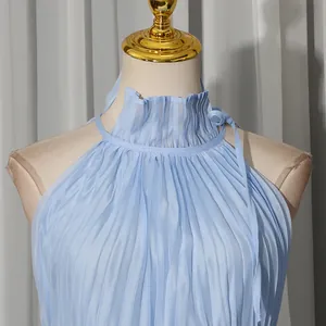 Close-up of the elegant light blue pleated halter neckline with ruffle trim
