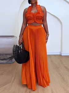 Stylish orange pleated two-piece set with halter ruffle top and high waist wide leg pants