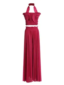 Magenta two-piece set with a halter ruffle crop top and high-waisted pleated wide-leg pants