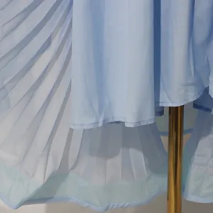 Detailed view of the light blue pleated fabric texture on a summer vacation maxi dress