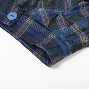Close-up detail of the waistband and button on a blue plaid mesh tutu skirt for women
