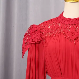 Detailed close-up of elegant red chiffon maxi dress with lace neck and pleated sleeves