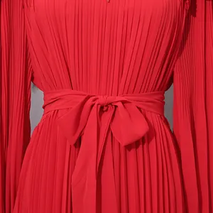 Detail view of an elegant red pleated chiffon maxi dress featuring a stylish waist-tie bow