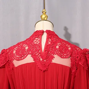 Close-up of red elegant dress featuring intricate lace collar and keyhole back detail