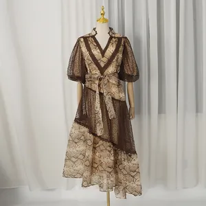 Close-up of French resort style snakeskin print dress with brown lace detailing and V-neck