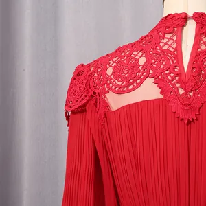 Detailed view of red chiffon dress featuring intricate lace shoulder embroidery and pleats