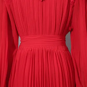Close-up view of red pleated chiffon dress waist with detailed fabric texture.