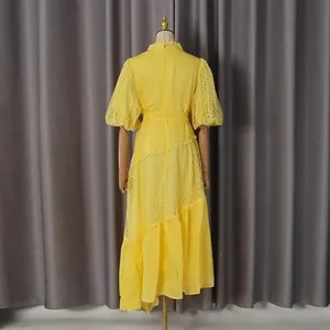 Back view detail of yellow French lace dress with puff sleeves and belted waist