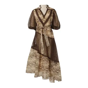 Detailed view of a V-neck lace midi dress with snake skin print and puff sleeves