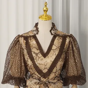 Detailed view of the elegant V-neck lace trim and snake print puff sleeves on a dress