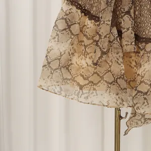 Close-up detail of French style yellow snakeskin print lace hem on holiday dress