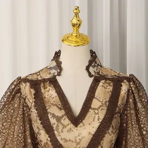 Close-up view of a French style dress featuring a V-neck, lace puff sleeves and animal print