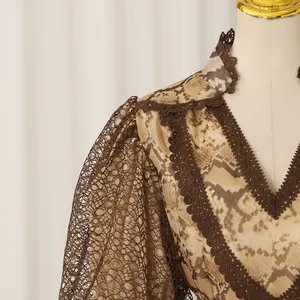 Exquisite close-up of snake skin print dress featuring brown lace trim and V-neckline