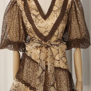 Detail view of French style snakeskin print dress with lace V-neck and puff sleeves