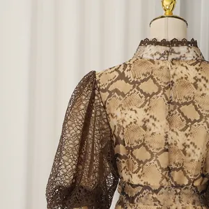 Detailed view of the puff sleeve and snakeskin pattern on this French style lace dress