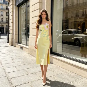 Elegant strapless yellow midi dress with 3D floral embroidery and side slit detail.