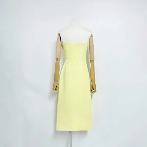 Detailed back view of a yellow strapless midi dress displayed on a wooden mannequin.