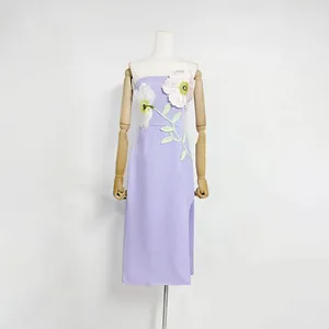 Exquisite 3D floral embroidery detail on a lavender strapless midi dress with side slit