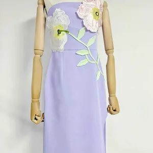 Close-up detail of 3D floral embroidery on a lavender purple strapless midi dress
