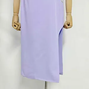 Detailed shot of a lavender midi dress featuring a high side slit and smooth fabric