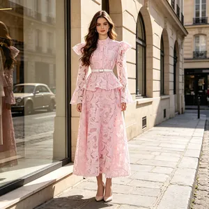 Elegant pink lace dress featuring bell sleeves and ruffled detail in a street setting.