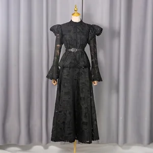 Full length view of a black vintage embroidered lace dress with bell sleeves on a mannequin.