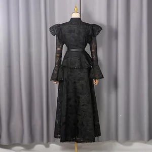 Detailed back view of vintage black lace maxi dress with elegant ruffles and bell sleeves