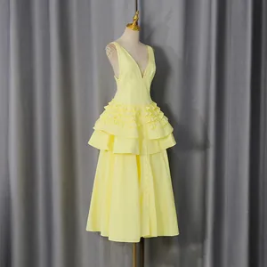 Detailed view of a yellow French vintage style tiered ruffle midi dress shown on a mannequin